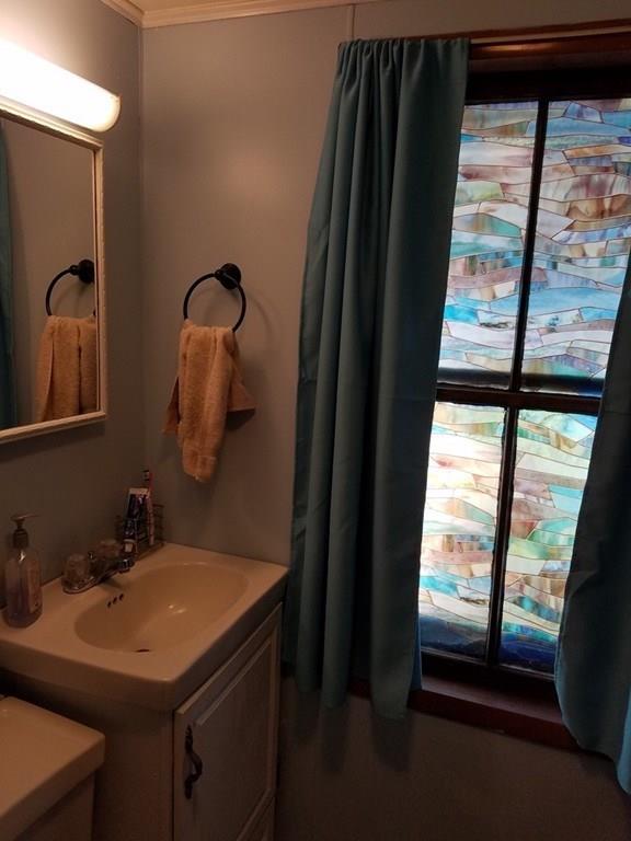 298 Deerfield Street Greenfield, MA 01301 - Photo 6 of 13 a bathroom with a sink and a mirror