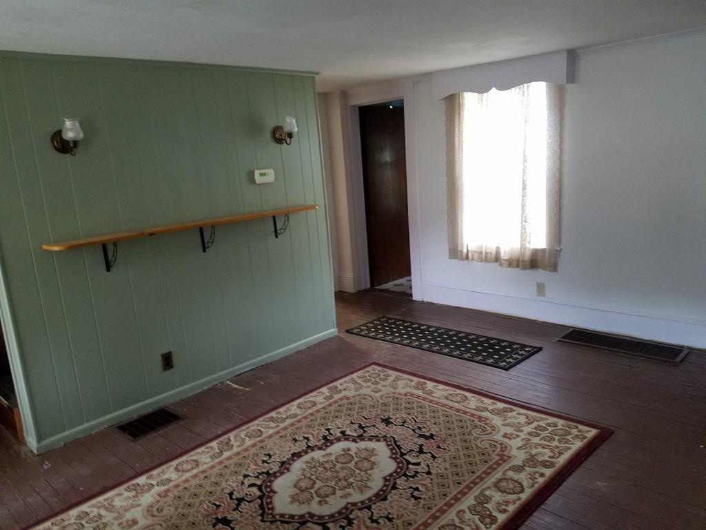 298 Deerfield Street Greenfield, MA 01301 - Photo 9 of 13 a view of a livingroom with wooden floor and a window