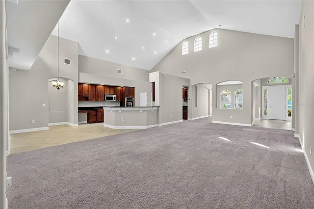 a view of a kitchen with a sink and a refrigerator