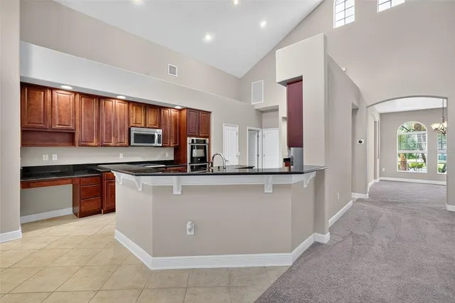 a open kitchen with stainless steel appliances granite countertop a stove sink and cabinets