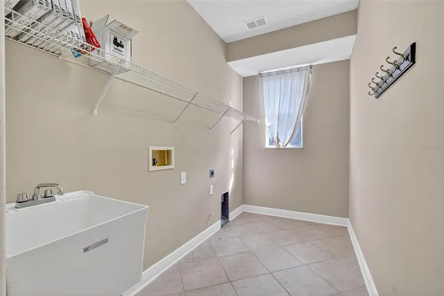 a view of a utility room with closet and windows