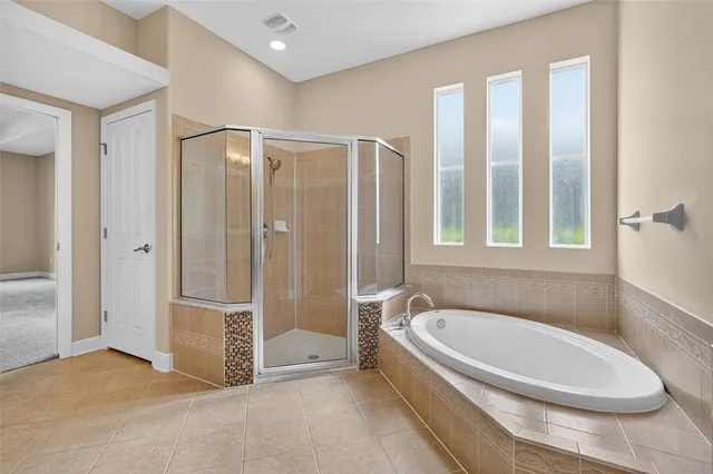 a bathroom with a tub and shower