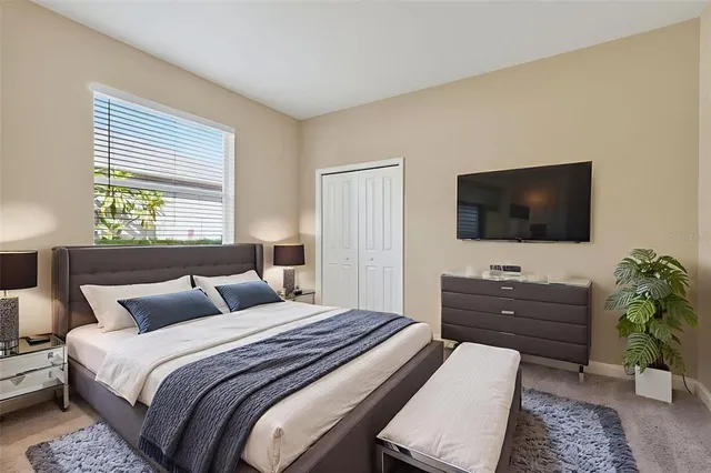 a bedroom with a bed and a flat screen tv