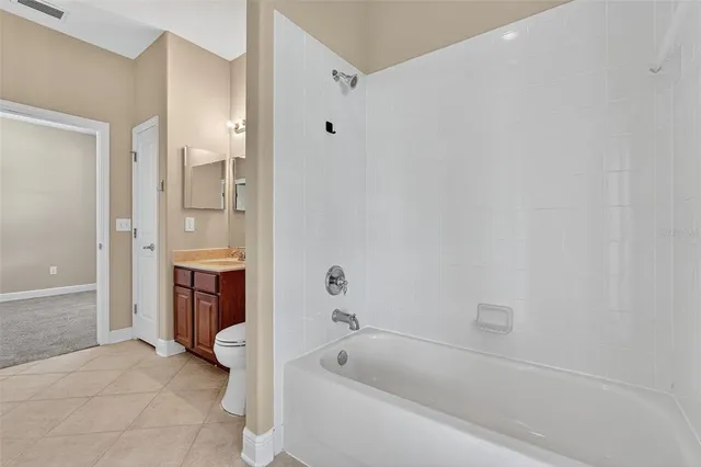 a spacious bathroom with a tub shower and sink