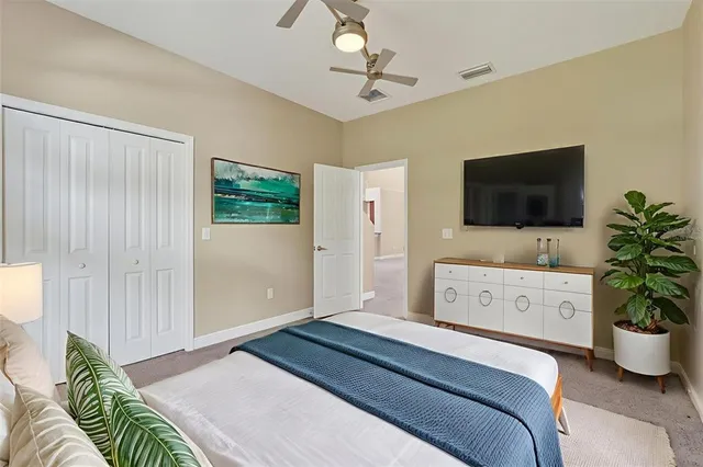 a bedroom with a bed and a flat screen tv