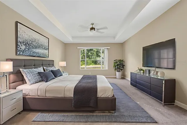 a bedroom with a large bed and a flat screen tv