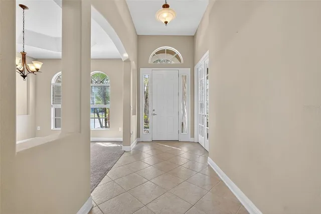 a view of a hallway with windows and entryway