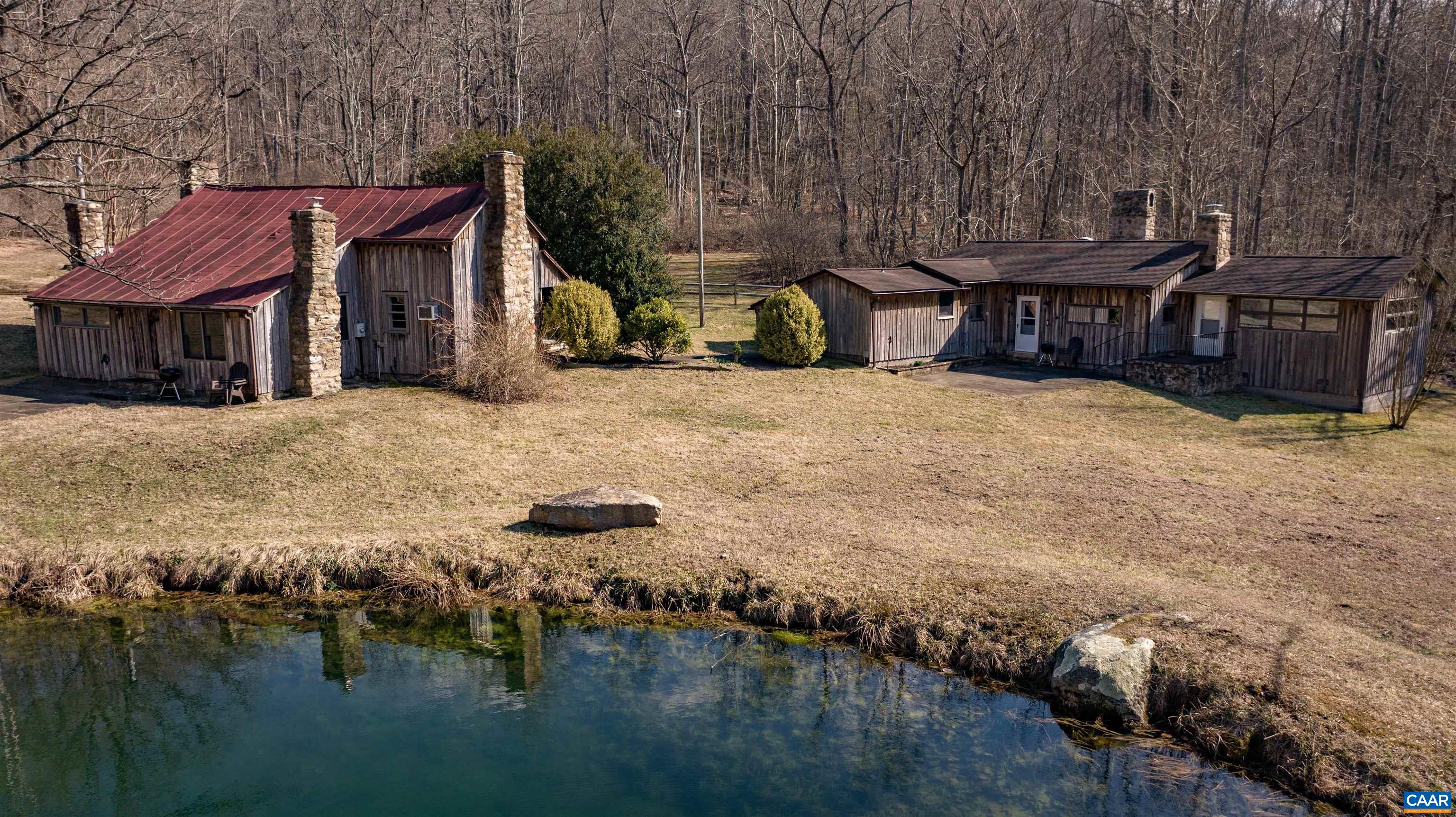 a view of a house with backyard and lake