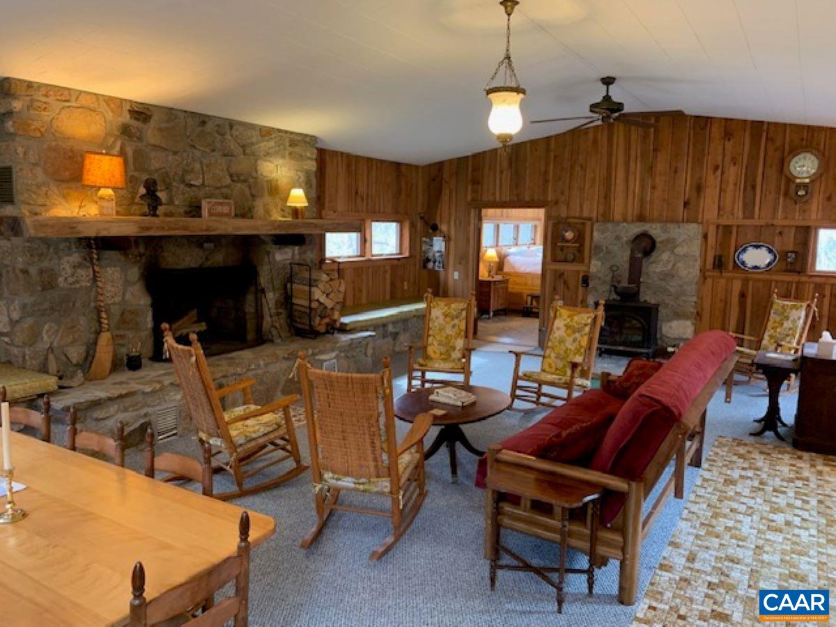 4873 Weakley Hollow Road Syria, VA 22743 - Photo 13 of 38 a living room with furniture a dining table and a fireplace