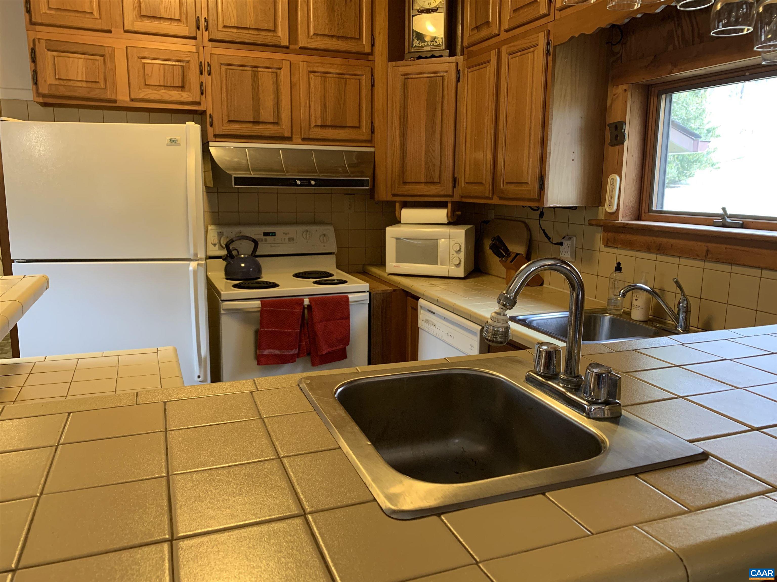 4873 Weakley Hollow Road Syria, VA 22743 - Photo 17 of 38 a kitchen with a sink and cabinets