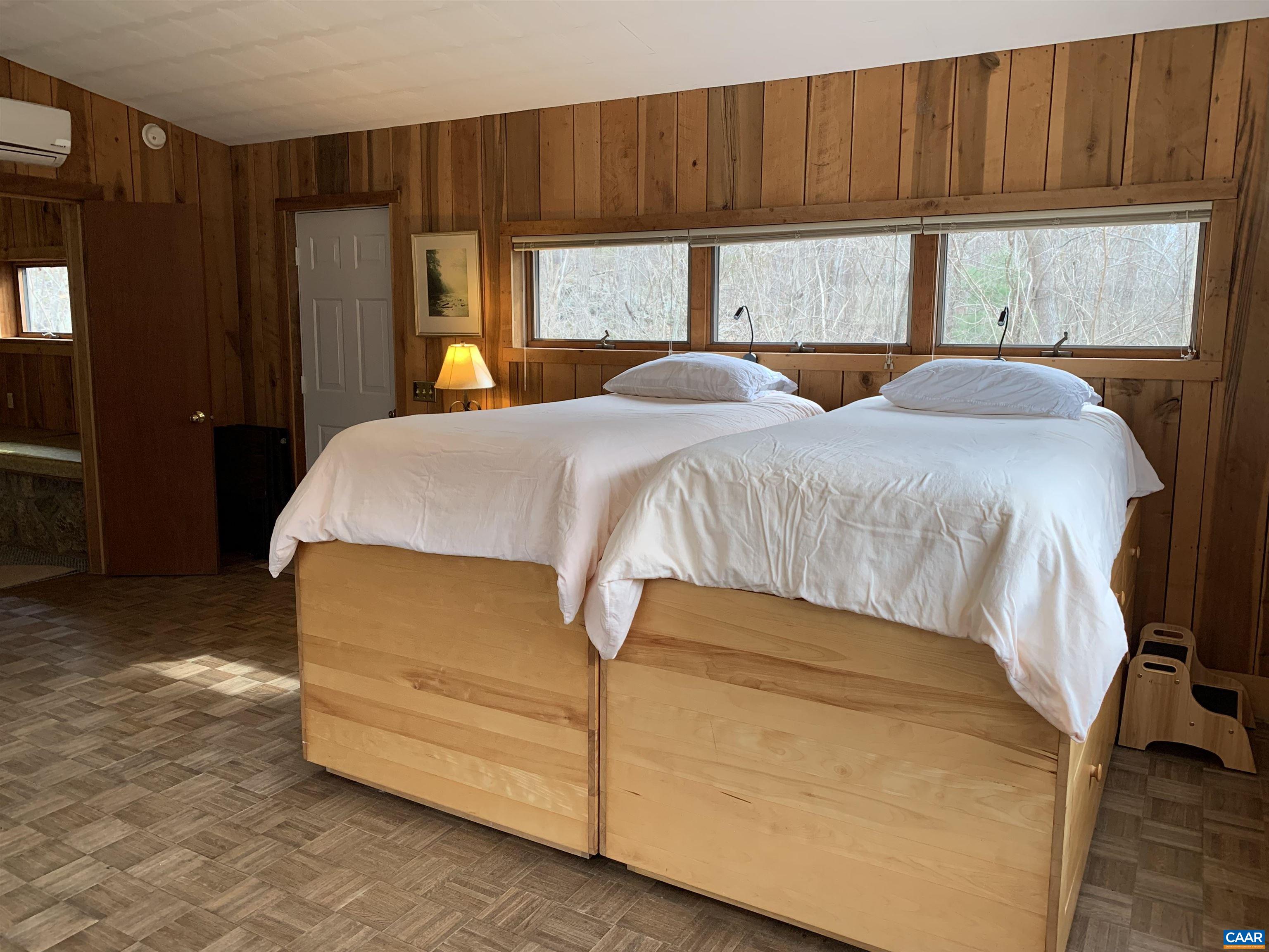 4873 Weakley Hollow Road Syria, VA 22743 - Photo 21 of 38 a bed sitting in a bedroom next to a window