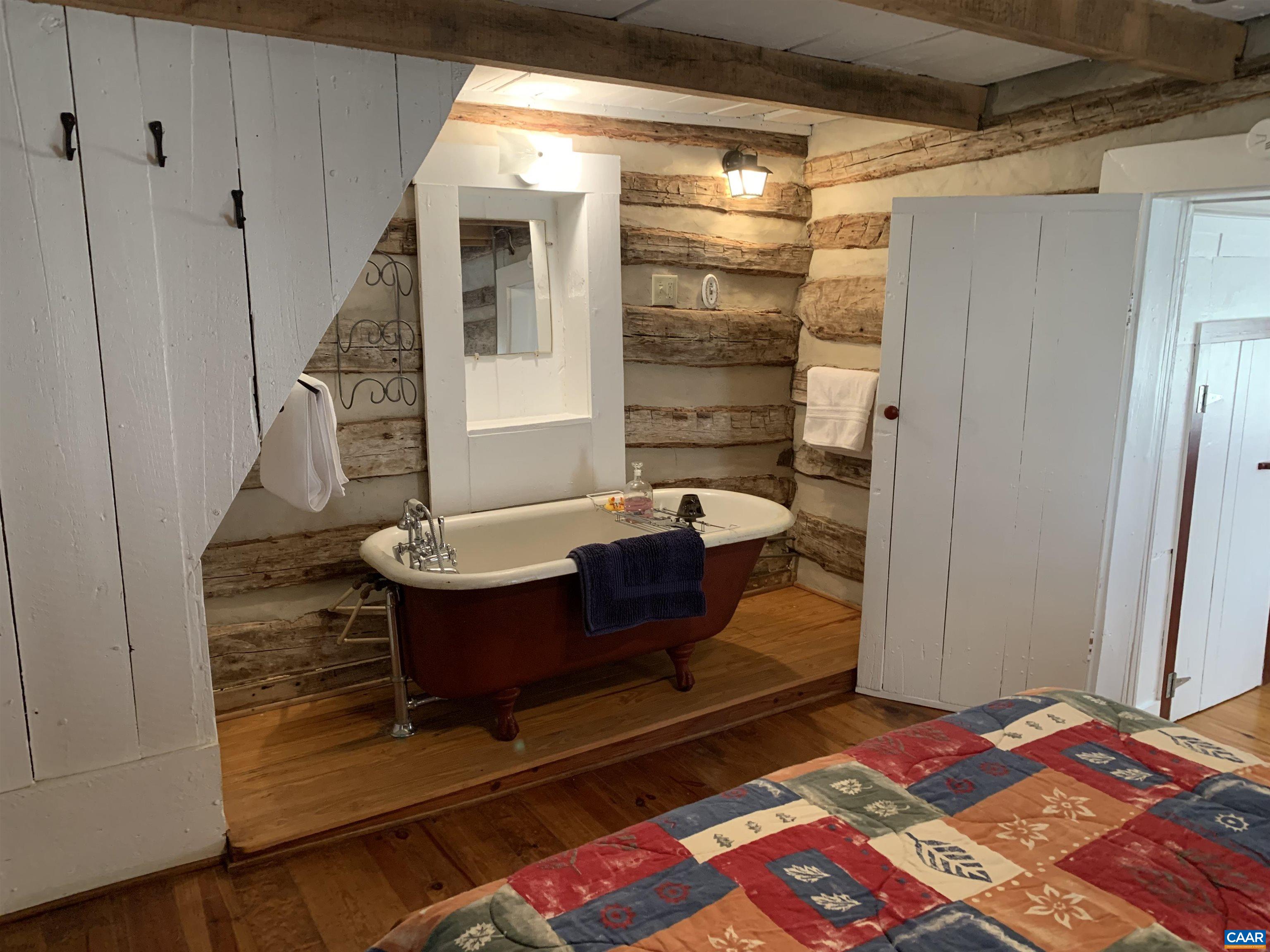 4873 Weakley Hollow Road Syria, VA 22743 - Photo 28 of 38 a bedroom with a bed and wooden floor