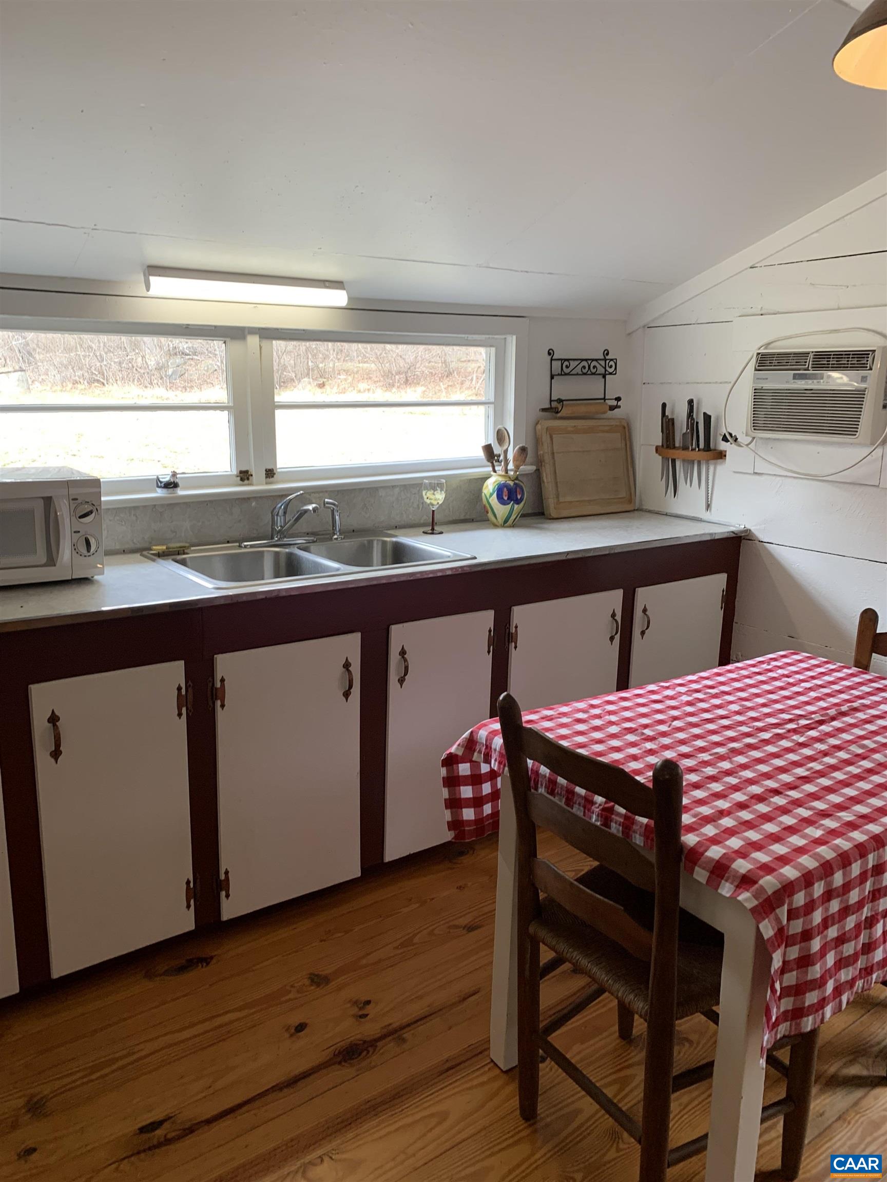 4873 Weakley Hollow Road Syria, VA 22743 - Photo 30 of 38 a kitchen with a sink and wooden cabinets