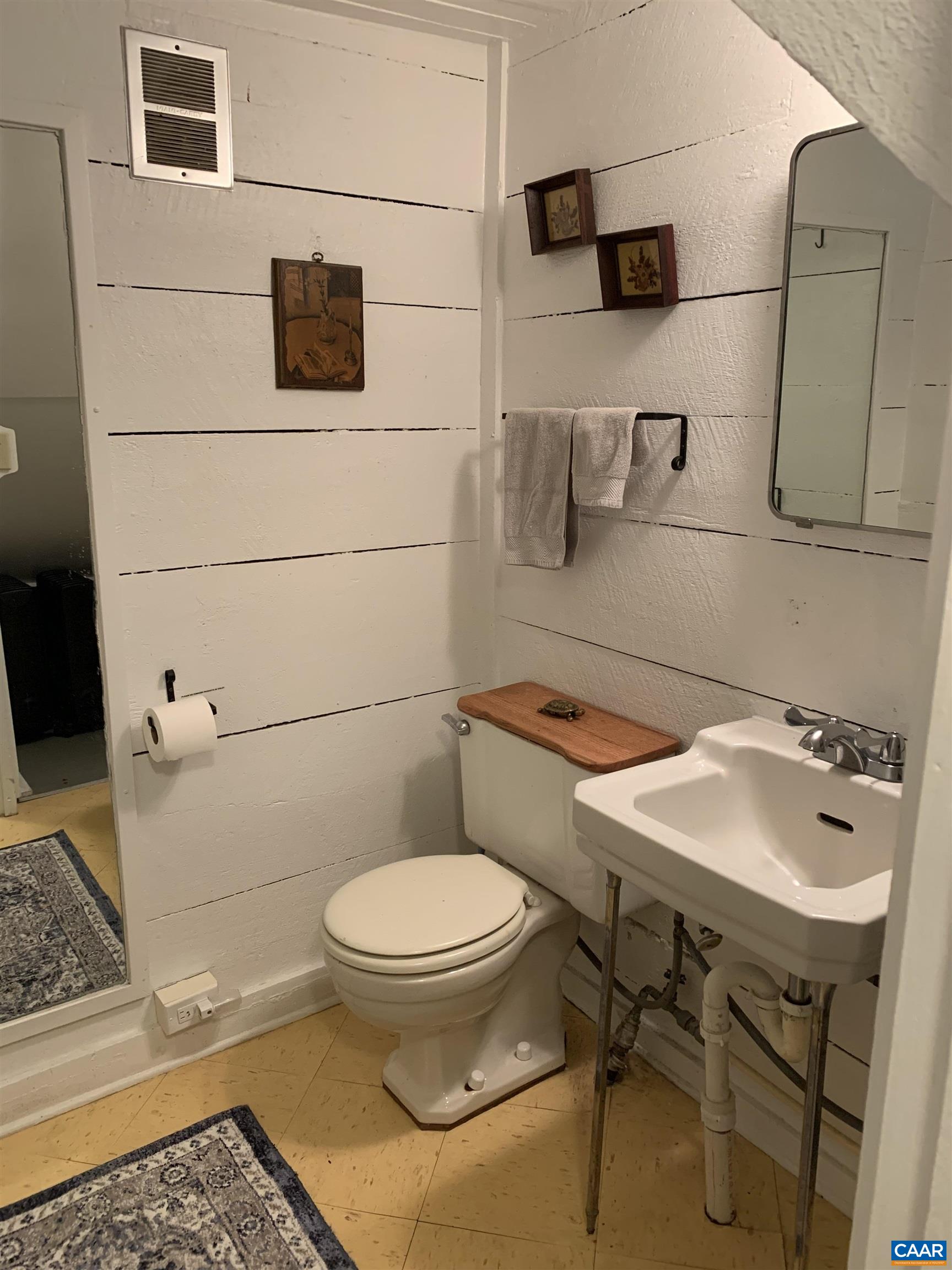 4873 Weakley Hollow Road Syria, VA 22743 - Photo 38 of 38 a bathroom with a sink toilet and mirror