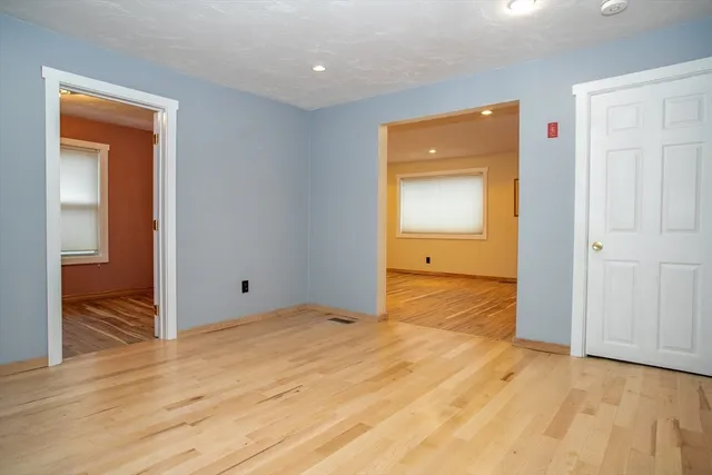 a view of a room with wooden floor and window