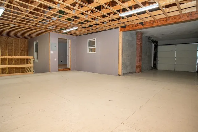 a view of a room with a wooden roof and potted plants