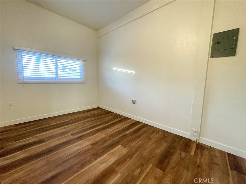 1334 East Brockton Avenue, Unit B Redlands, CA 92374 - Photo 11 of 14 a view of a room with wooden floor and a window