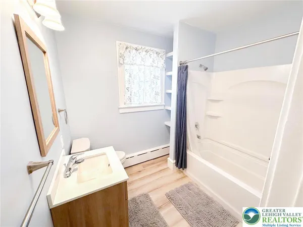 a bathroom with a sink a bath tub and a shower