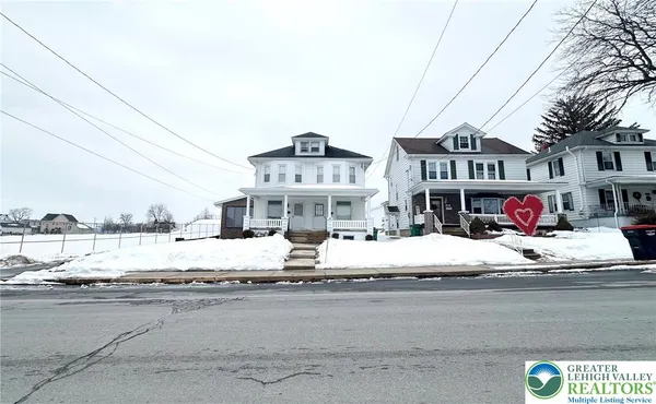 a view of a street with a building in the background