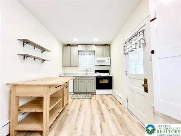 a kitchen with stainless steel appliances a stove a sink and a refrigerator