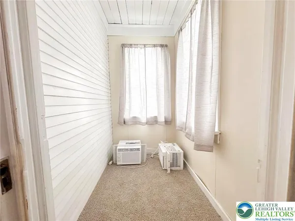 a bathroom with a sink and a bathtub next to a window