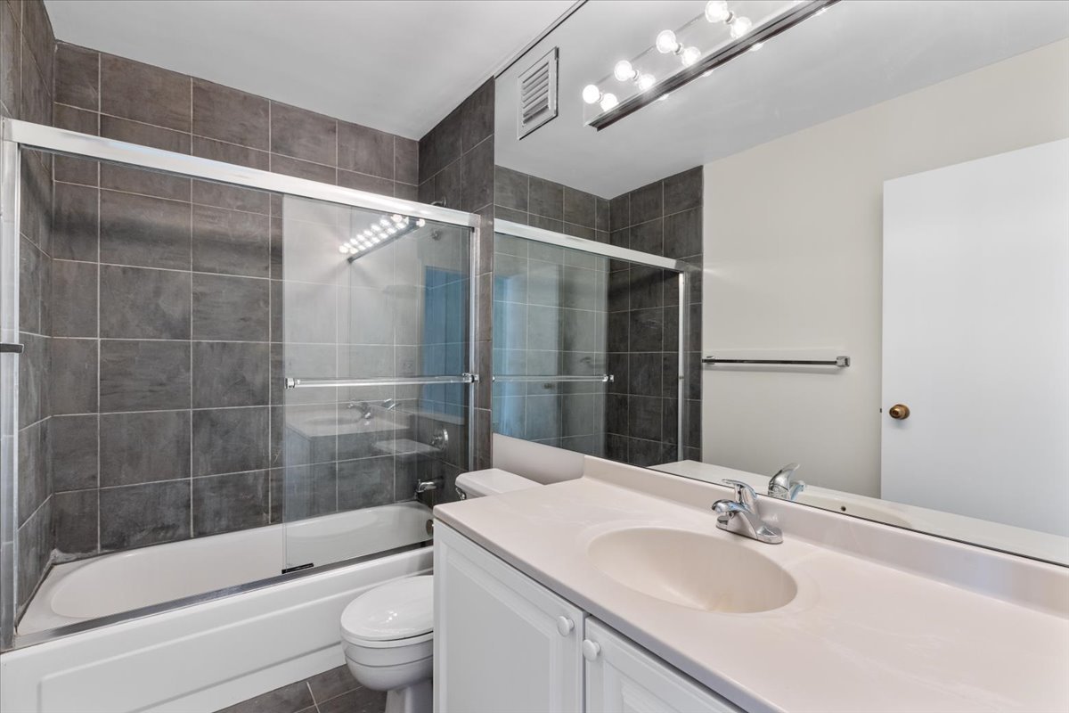 111 West Maple Street, Unit 3001 Chicago, IL 60610 - Photo 12 of 13 a bathroom with a sink a toilet and shower