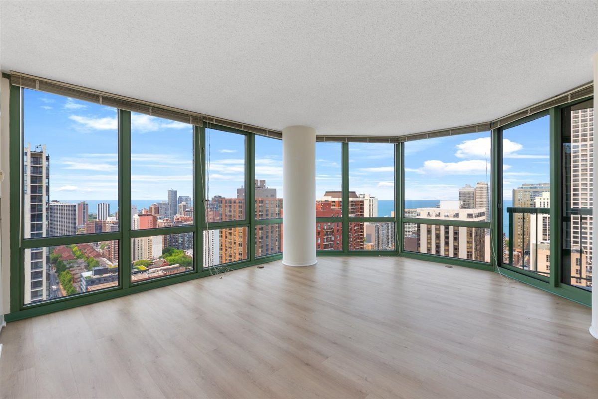 111 West Maple Street, Unit 3001 Chicago, IL 60610 - Photo 2 of 13 a view of an empty room window and wooden floor