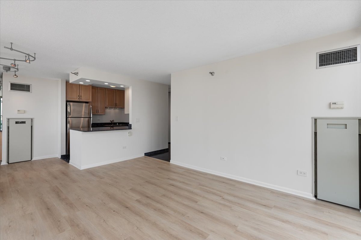 111 West Maple Street, Unit 3001 Chicago, IL 60610 - Photo 5 of 13 a view of a kitchen with a sink and a refrigerator