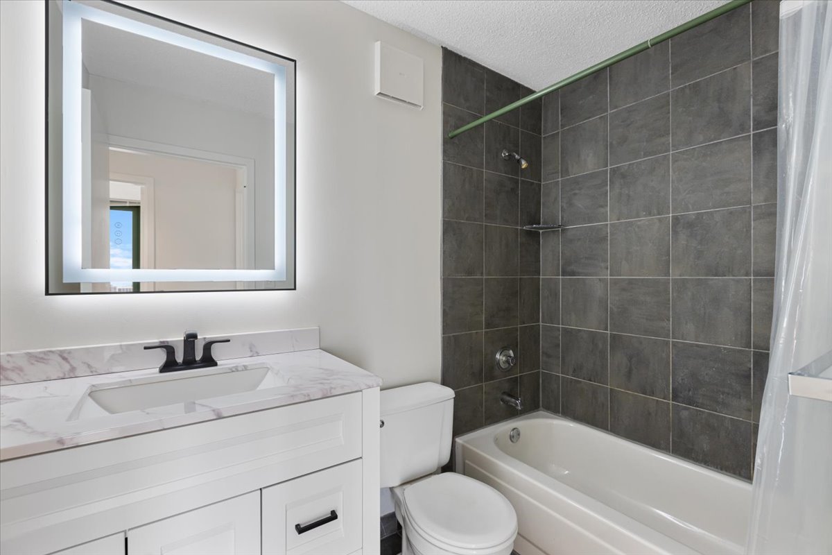 111 West Maple Street, Unit 3001 Chicago, IL 60610 - Photo 9 of 13 a bathroom with a sink toilet and shower