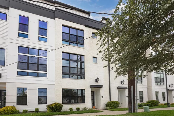 a front view of a building with a garden