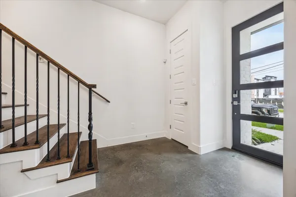 a view of a room with staircase and white walls