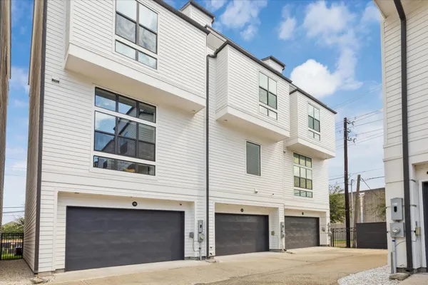 a front view of a building with a garden