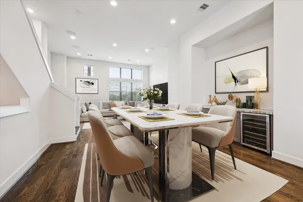 a view of a dining room with furniture and wooden floor