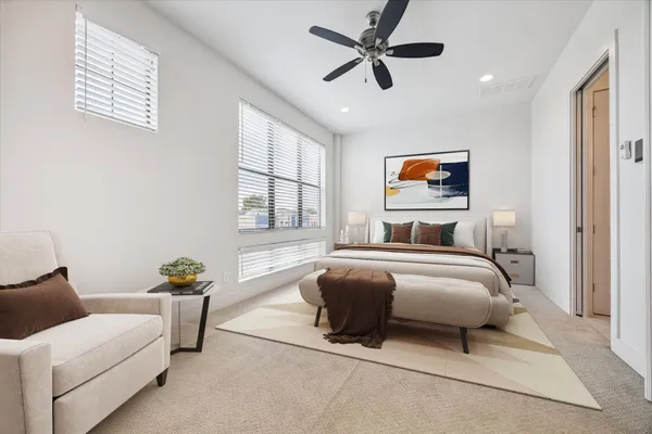 a bedroom with a bed couch and window