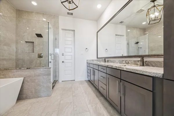 a bathroom with a granite countertop sink mirror and shower