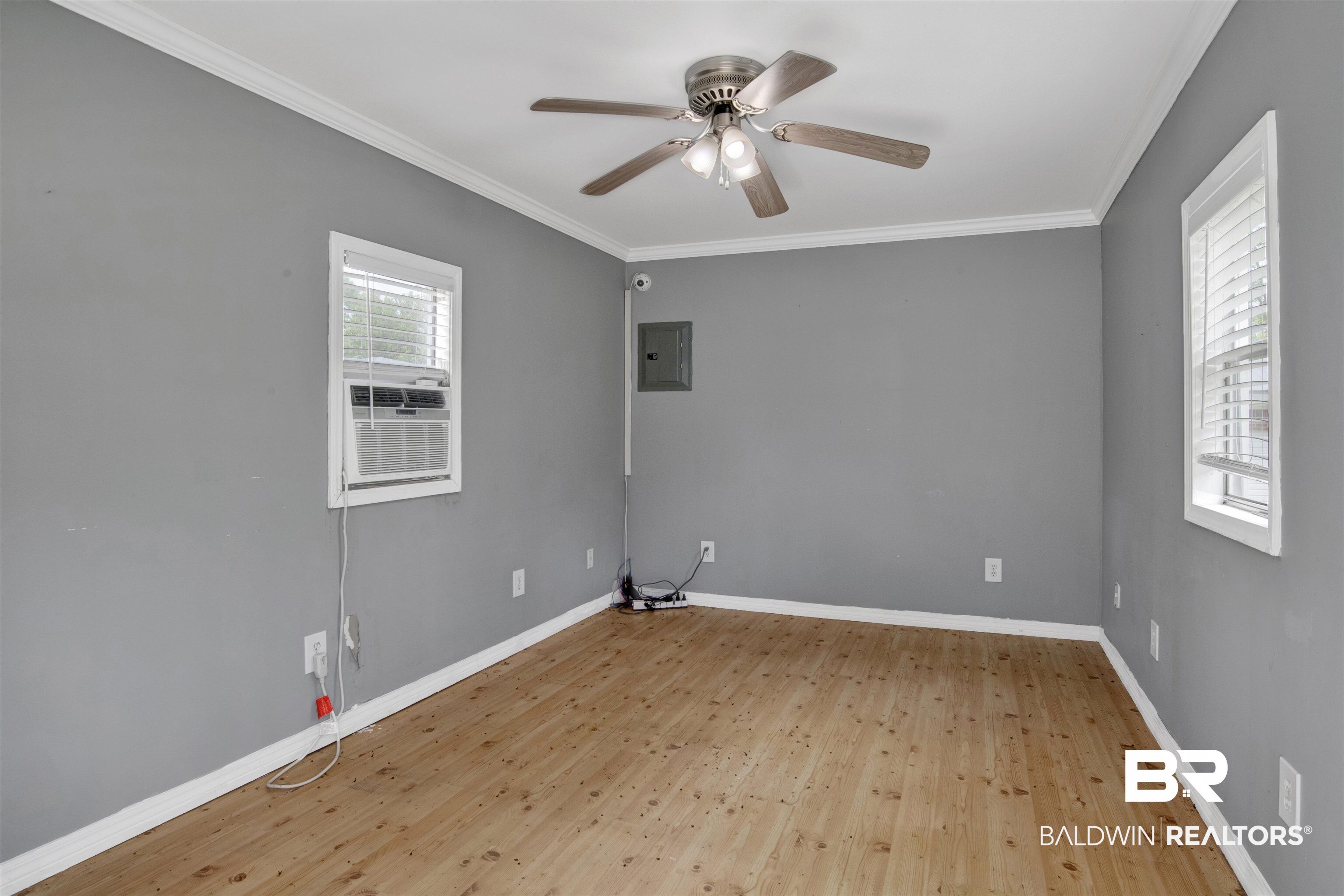 17714 Horseneck Road Bay Minette, AL 36507 - Photo 25 of 36 Spacious room with wood-finish flooring, neutral gray walls, and white crown molding