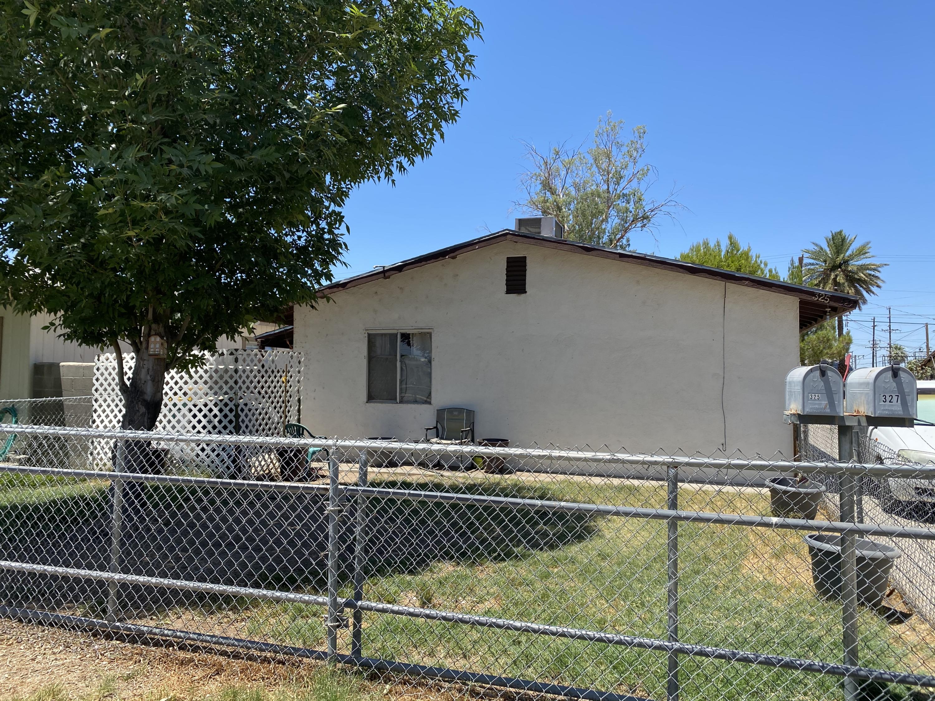 325 South Spring Street Blythe, CA 92225 - Photo 2 of 10 a view of a house with a swimming pool