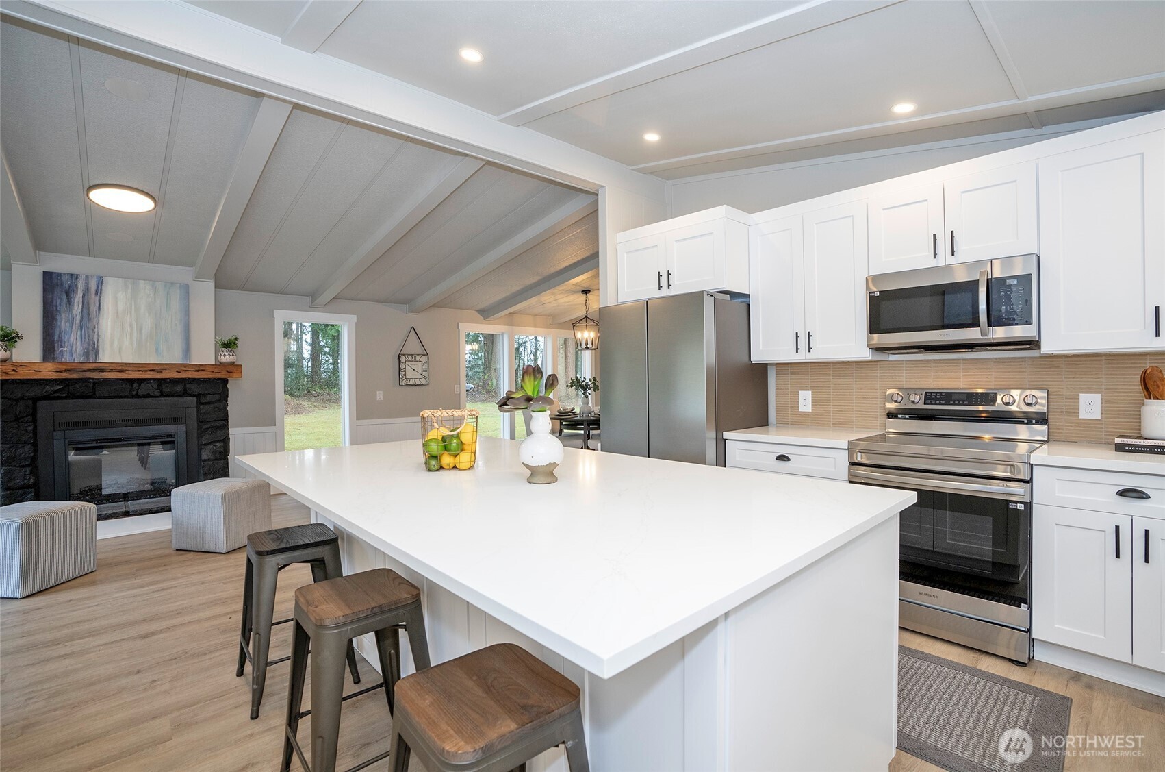 11810 Driver Street Southwest Olympia, WA 98512 - Photo 14 of 40 a kitchen with stainless steel appliances a stove refrigerator sink microwave and cabinets