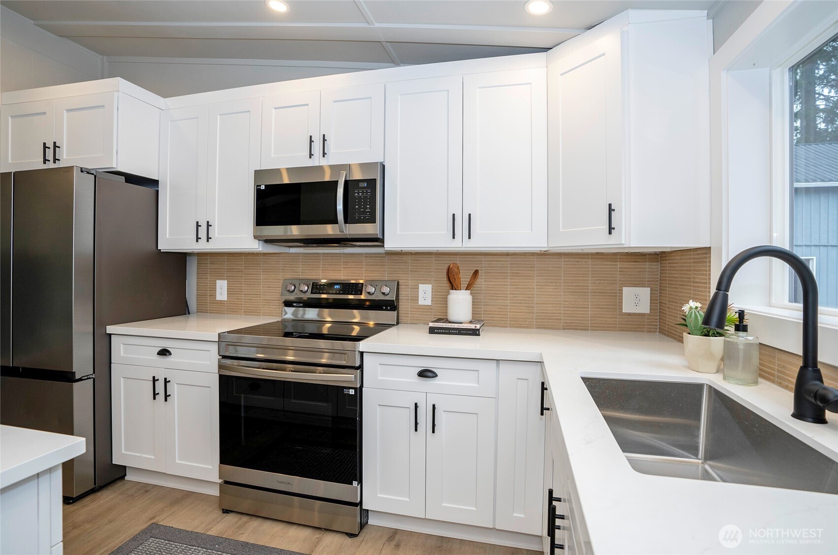 11810 Driver Street Southwest Olympia, WA 98512 - Photo 15 of 40 a kitchen with cabinets stainless steel appliances and sink