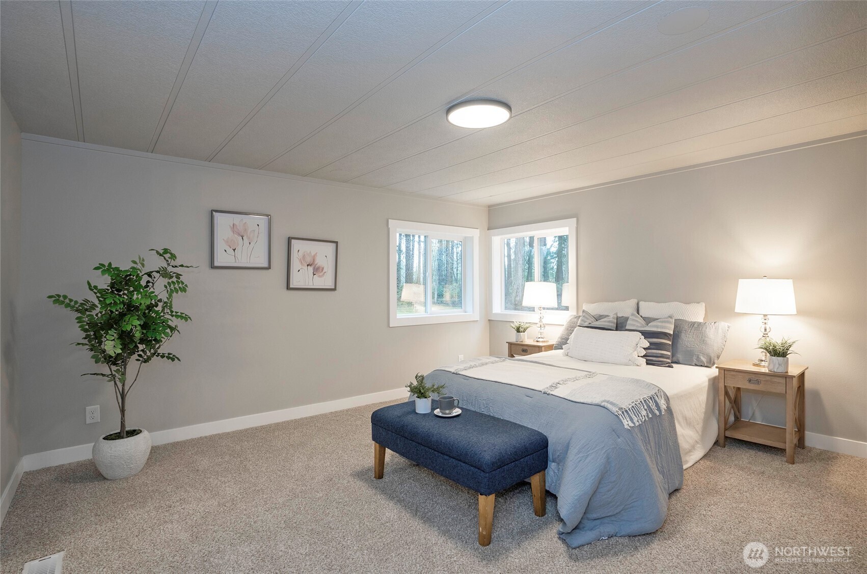 11810 Driver Street Southwest Olympia, WA 98512 - Photo 19 of 40 a bedroom with a bed and a potted plant