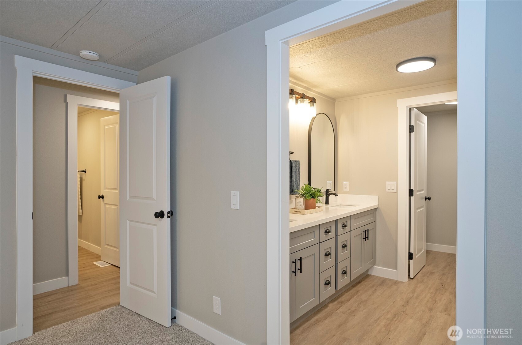 11810 Driver Street Southwest Olympia, WA 98512 - Photo 22 of 40 a spacious bathroom with a double vanity sink and a mirror