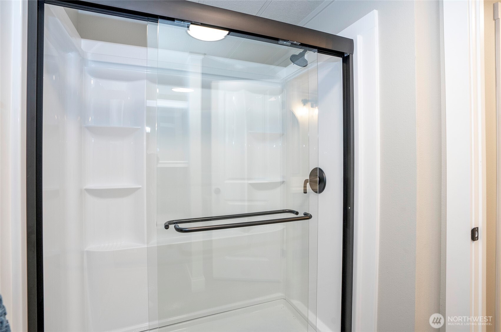 11810 Driver Street Southwest Olympia, WA 98512 - Photo 25 of 40 a bathroom with a glass shower door