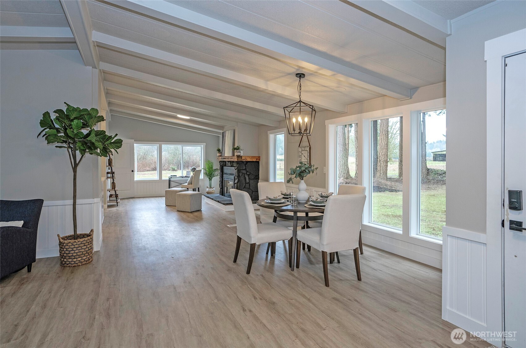 11810 Driver Street Southwest Olympia, WA 98512 - Photo 9 of 40 a dining room with furniture potted plants and wooden floor
