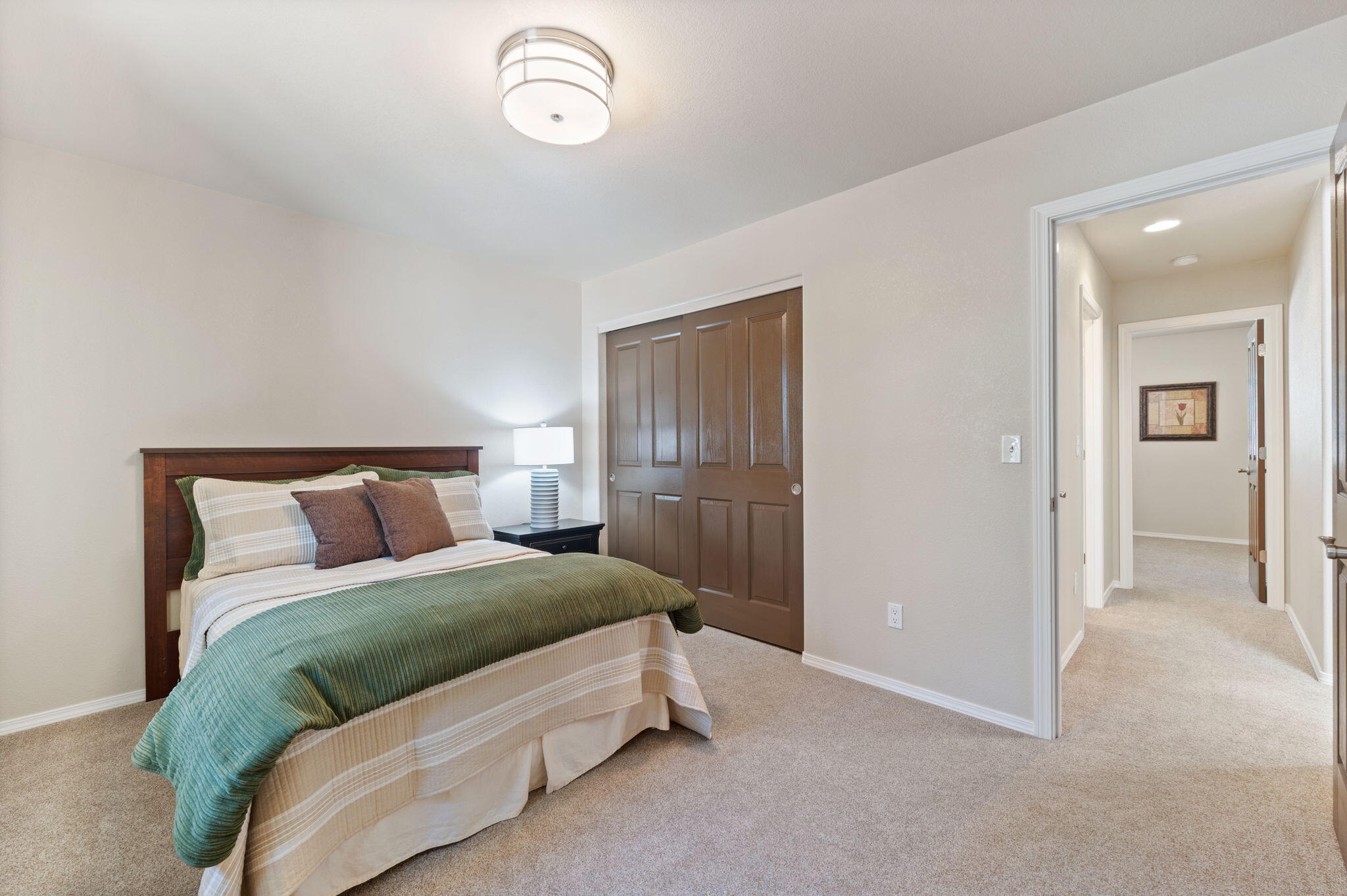 16938 Quartz Hill Road Bend, OR 97707 - Photo 28 of 52 a bedroom with a bed and a lamp
