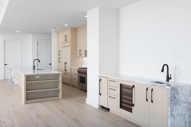 a kitchen with stainless steel appliances a sink and cabinets