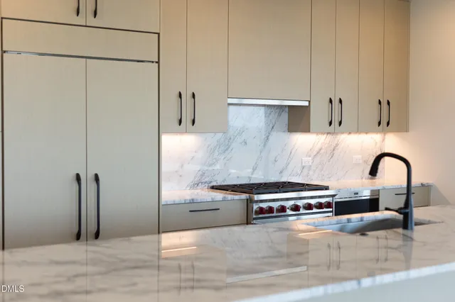 a view of a kitchen with a sink and cabinets
