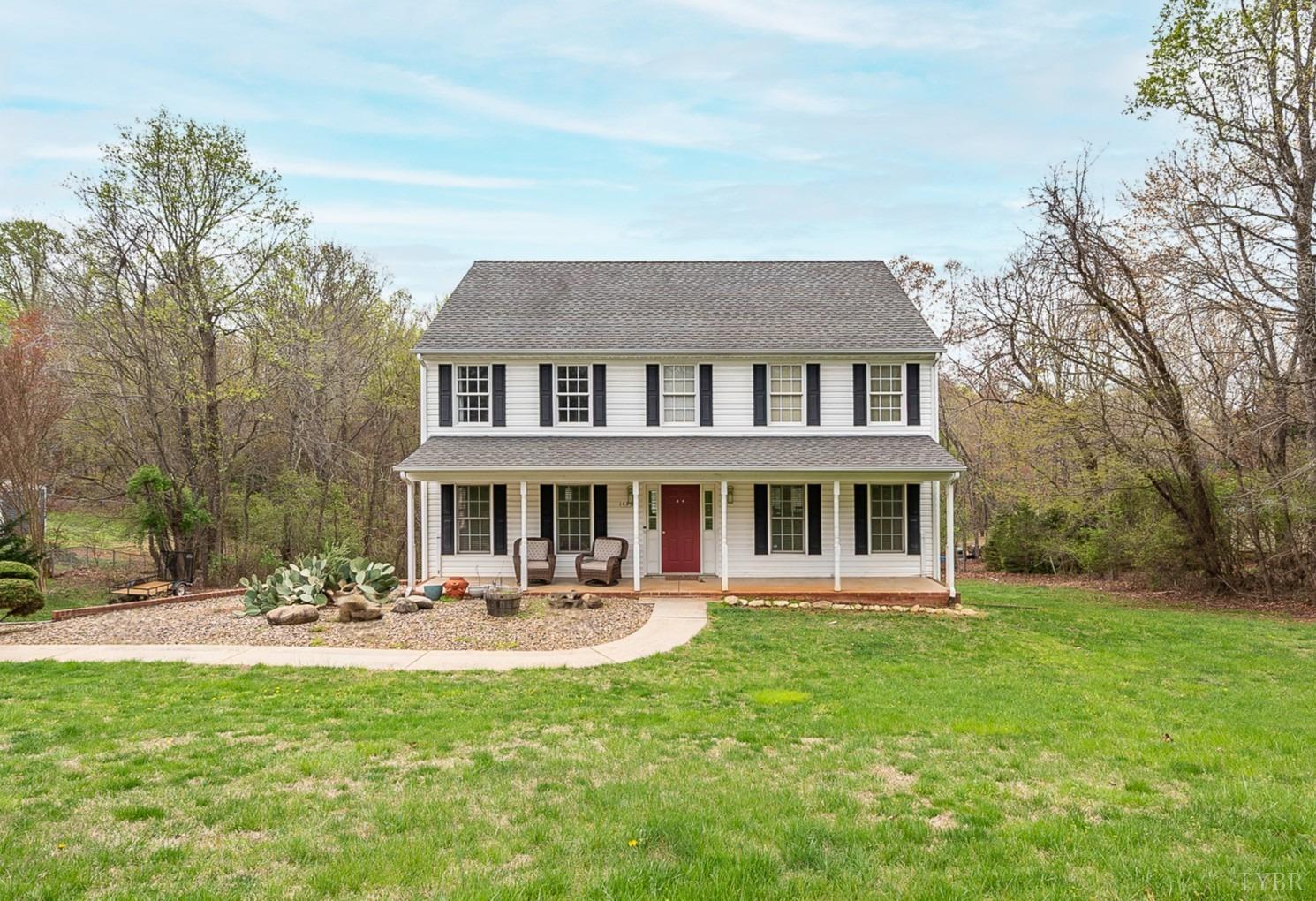 a front view of a house with swimming pool and glass windows