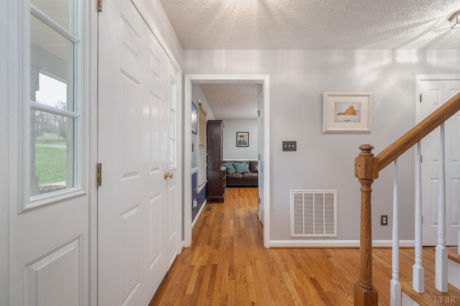 1498 Hooper Road Forest, VA 24551 - Photo 21 of 48 a view of a hallway with wooden floor and windows