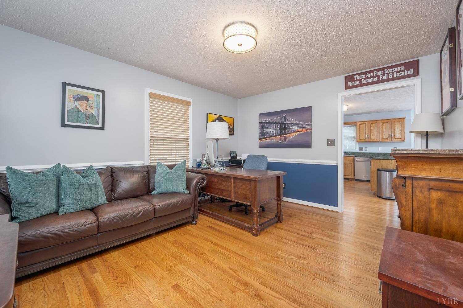 1498 Hooper Road Forest, VA 24551 - Photo 23 of 48 a living room with furniture and a wooden floor