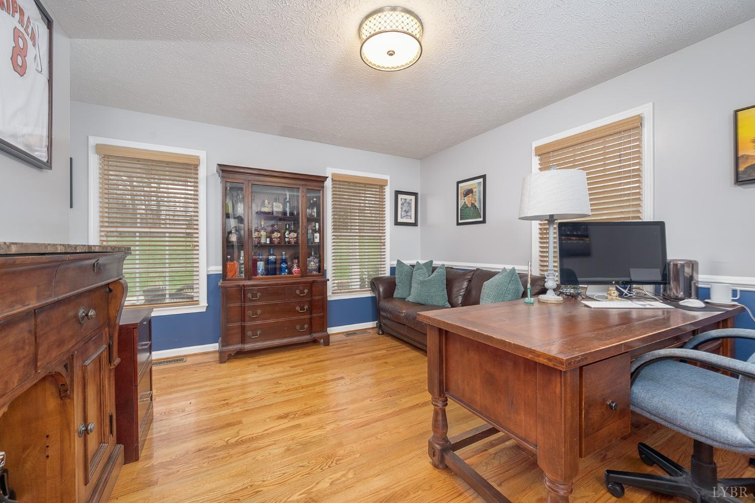 1498 Hooper Road Forest, VA 24551 - Photo 24 of 48 a room with furniture a flat screen tv and a fireplace